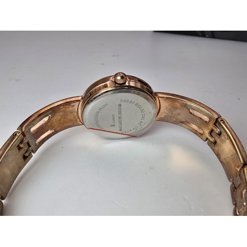 236 - An as new Rennie Mackintosh ladies quartz watch with a rose gold tone strap and case featuring a cla... 