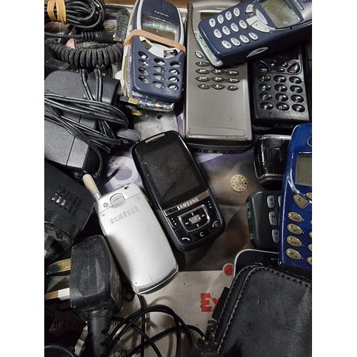 11 - A box containing a large quantity of mobile hones of various brands including blackberry Ericsson, N... 