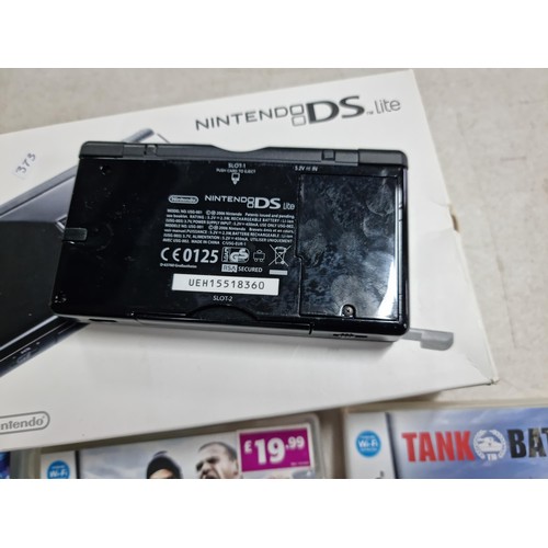 15 - A boxed Nintendo DS lite in black and grey along with its charger along with 4 boxed games.