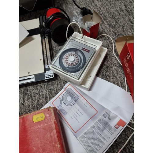 22 - A box containing a quantity of photographic development accessories to include an Ilford EM10 enlarg... 