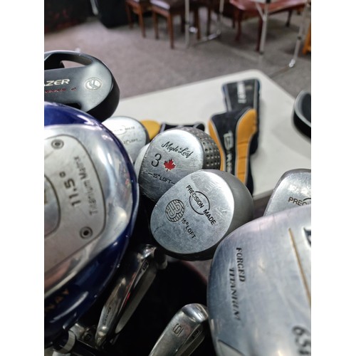 28A - A large golf set containing 12 woods of various brands, 9 irons and 2 putters including the brands D... 