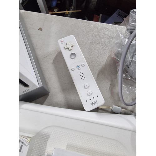 41 - A Nintendo Wii console along with a Wii fit board. includes, Tiger woods PGA Tour game along with ac... 