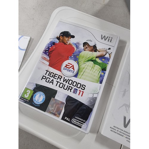 41 - A Nintendo Wii console along with a Wii fit board. includes, Tiger woods PGA Tour game along with ac... 