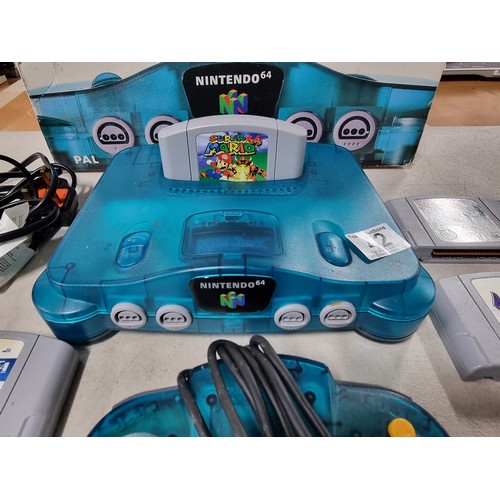 42 - A boxed Nintendo 64 limited edition clear blue with a selection of games.