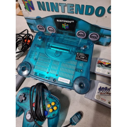 42 - A boxed Nintendo 64 limited edition clear blue with a selection of games.