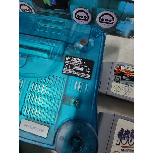 42 - A boxed Nintendo 64 limited edition clear blue with a selection of games.