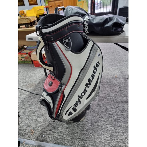 39 - A good quality Taylormade golf bag complete with waterproof hood and carrying strap, in good overall... 