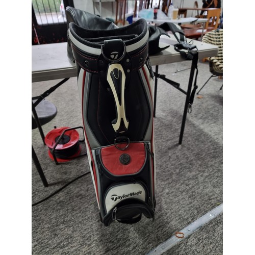 39 - A good quality Taylormade golf bag complete with waterproof hood and carrying strap, in good overall... 