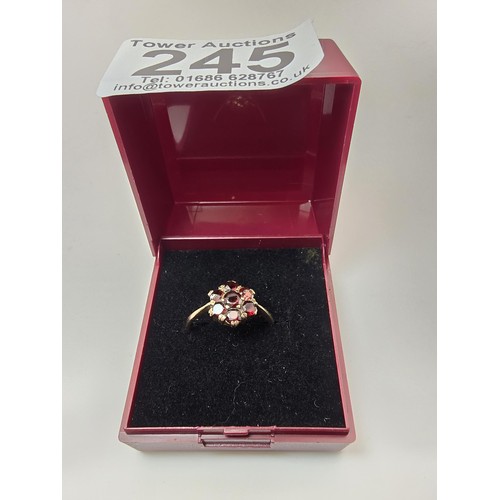 249 - A vintage hallmarked 9ct yellow gold garnet cluster ring featuring 7 faceted garnet gemstones which ... 