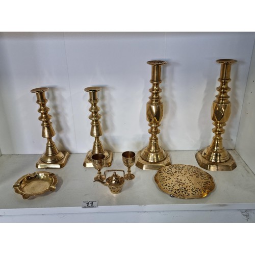 11 - A quantity of brass ware including a pair of good quality The diamond Prince candlesticks along with... 