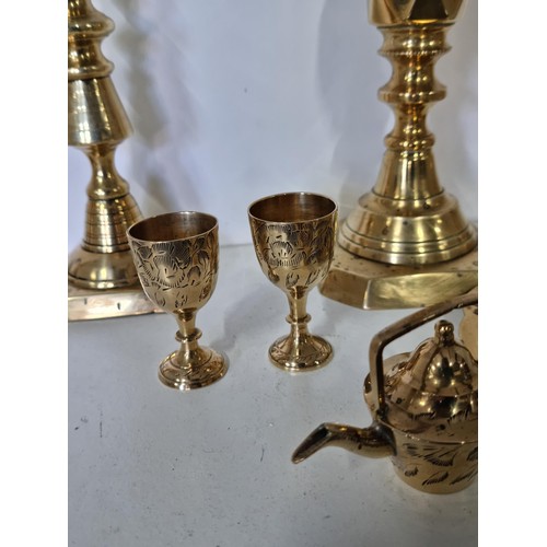 11 - A quantity of brass ware including a pair of good quality The diamond Prince candlesticks along with... 