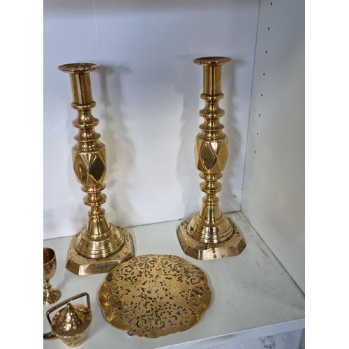 11 - A quantity of brass ware including a pair of good quality The diamond Prince candlesticks along with... 