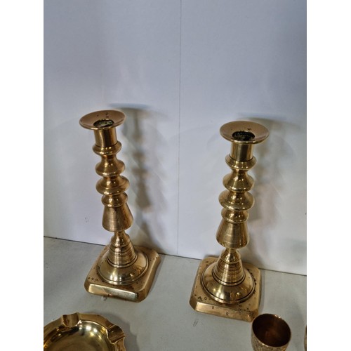 11 - A quantity of brass ware including a pair of good quality The diamond Prince candlesticks along with... 