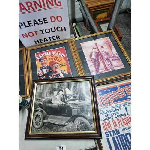 21 - A large collection of Laurel and Hardy collectables including an reproduction advertising poster for... 