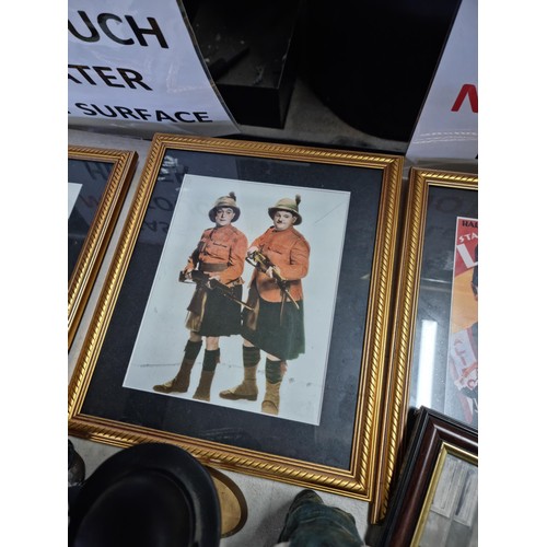 21 - A large collection of Laurel and Hardy collectables including an reproduction advertising poster for... 