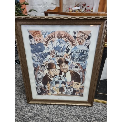 21 - A large collection of Laurel and Hardy collectables including an reproduction advertising poster for... 