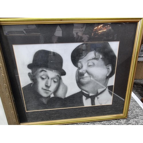 21 - A large collection of Laurel and Hardy collectables including an reproduction advertising poster for... 