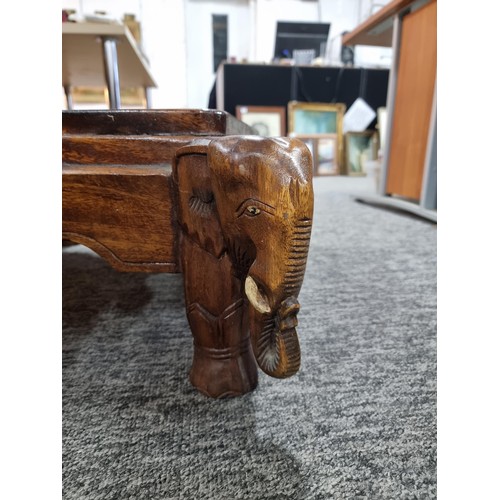 27 - Good quality solid wooden carved elephant heads accent table in good order with heart scrolling arou... 