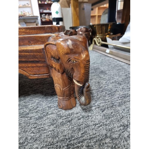 27 - Good quality solid wooden carved elephant heads accent table in good order with heart scrolling arou... 