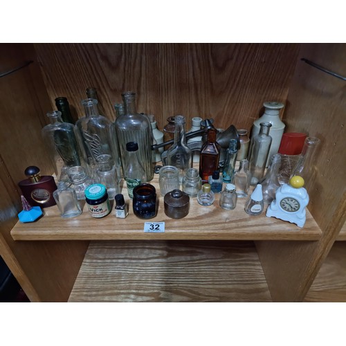 32 - Shelf full of collectable vintage and antique glass and earthenware inc Boots Chemist bottles, a Qui... 