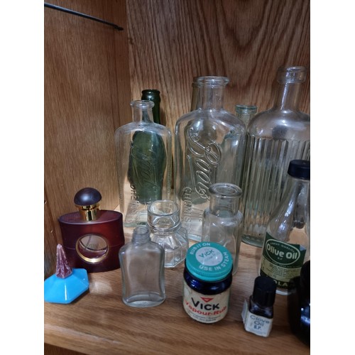 32 - Shelf full of collectable vintage and antique glass and earthenware inc Boots Chemist bottles, a Qui... 