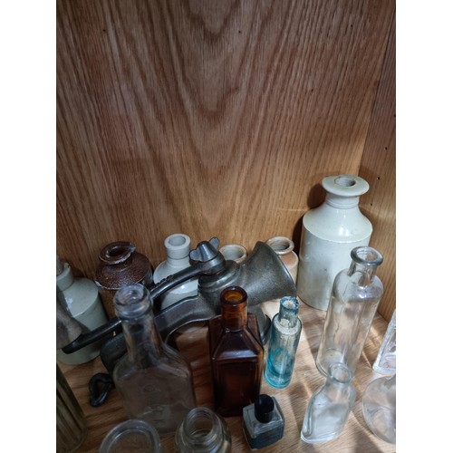 32 - Shelf full of collectable vintage and antique glass and earthenware inc Boots Chemist bottles, a Qui... 