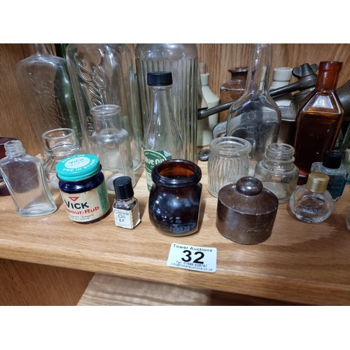 32 - Shelf full of collectable vintage and antique glass and earthenware inc Boots Chemist bottles, a Qui... 