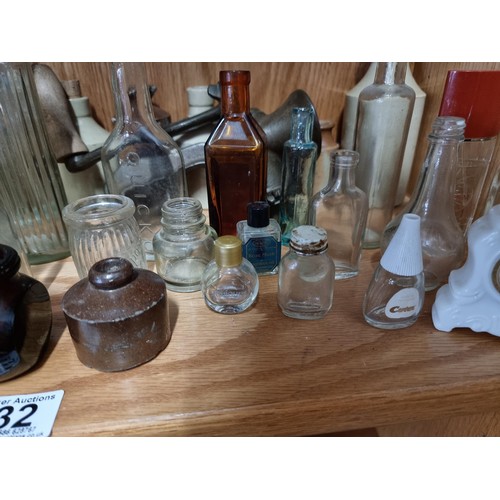 32 - Shelf full of collectable vintage and antique glass and earthenware inc Boots Chemist bottles, a Qui... 