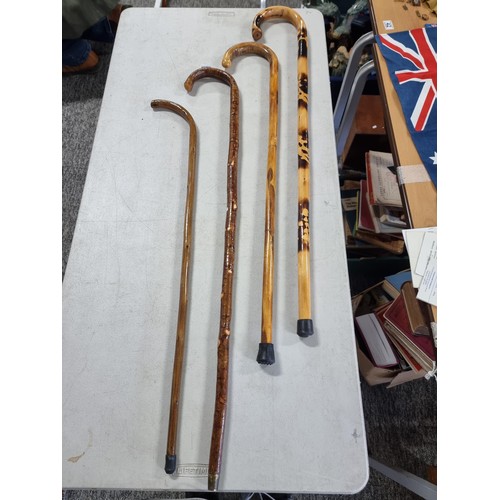 39 - Quantity of 4x good quality wooden hand made walking sticks all have been varnished one with a scorc... 