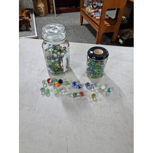 49 - 2x Jars of marbles of various designs inc iridescent marbles, green and white marbles etc, please se... 