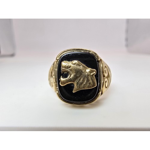 252 - A stunning hallmarked 9ct yellow gold unisex signet ring featuring a black onyx stone with an overla... 