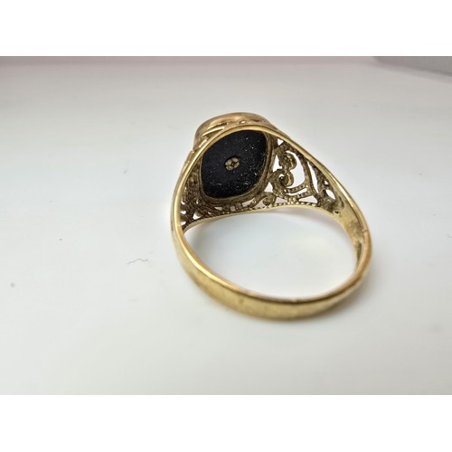 252 - A stunning hallmarked 9ct yellow gold unisex signet ring featuring a black onyx stone with an overla... 