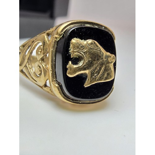 252 - A stunning hallmarked 9ct yellow gold unisex signet ring featuring a black onyx stone with an overla... 