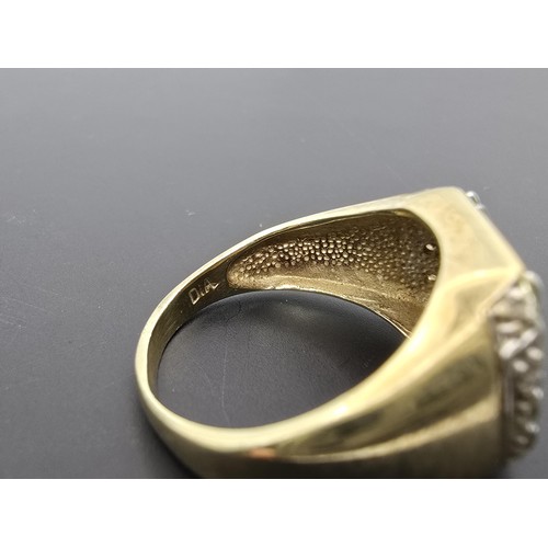 253 - An attractive hallmarked 9ct yellow gold gents signet ring featuring a pretty white gold overlaid ea... 