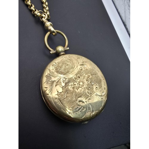 256 - A very pretty ornate gold plated fob locket set with a very long antique 60