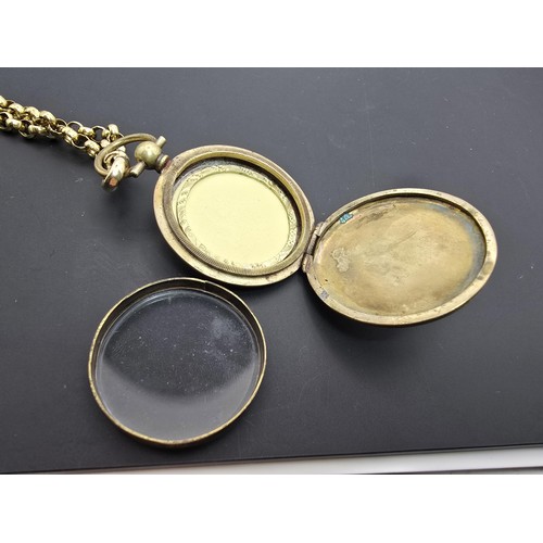 256 - A very pretty ornate gold plated fob locket set with a very long antique 60