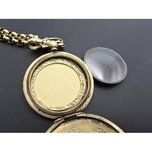 256 - A very pretty ornate gold plated fob locket set with a very long antique 60