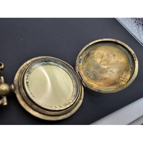 256 - A very pretty ornate gold plated fob locket set with a very long antique 60