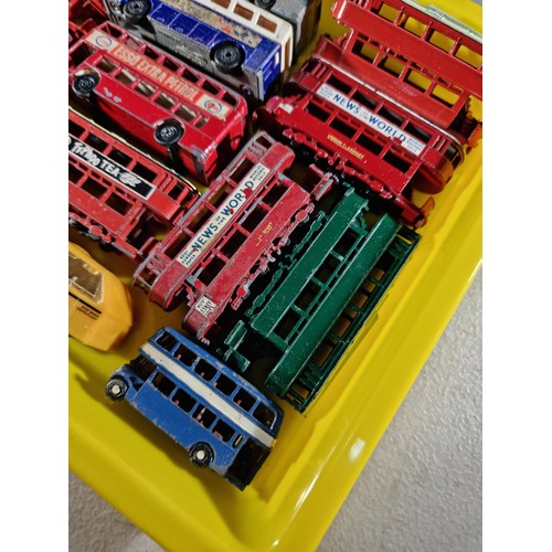 67 - Small tray containing a quantity of 14x Trams and buses, some with advertising inc Ty-Phoo Tea, News... 