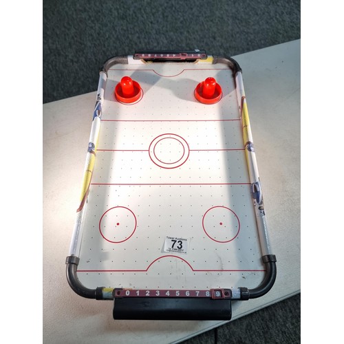 73 - Good quality table top air hockey table with fan underneath complete with disks 55cm long and 31cm w... 