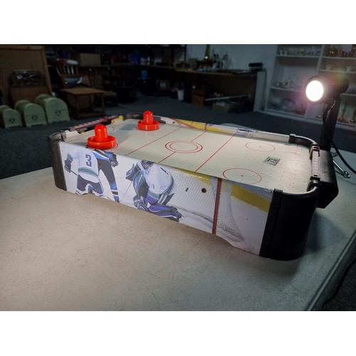 73 - Good quality table top air hockey table with fan underneath complete with disks 55cm long and 31cm w... 