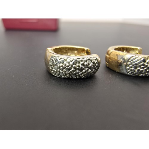 263A - A pair of small chunky 9ct yellow gold hinged earrings featuring a white gold studded design to the ... 