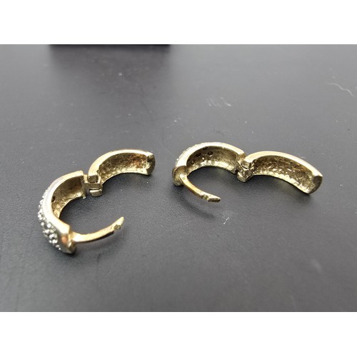 263A - A pair of small chunky 9ct yellow gold hinged earrings featuring a white gold studded design to the ... 