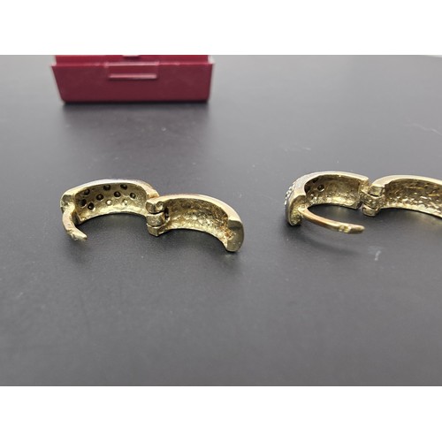 263A - A pair of small chunky 9ct yellow gold hinged earrings featuring a white gold studded design to the ... 