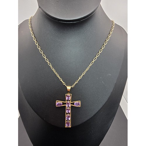 257 - A very pretty hallmarked 9ct yellow gold Cross pendant inset with 7 large faceted amethyst gemstones... 