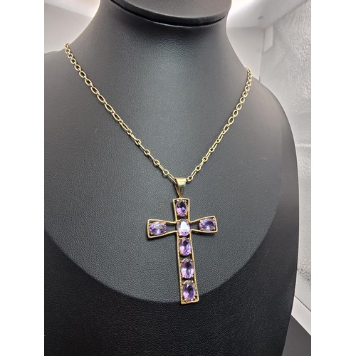 257 - A very pretty hallmarked 9ct yellow gold Cross pendant inset with 7 large faceted amethyst gemstones... 