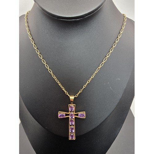 257 - A very pretty hallmarked 9ct yellow gold Cross pendant inset with 7 large faceted amethyst gemstones... 