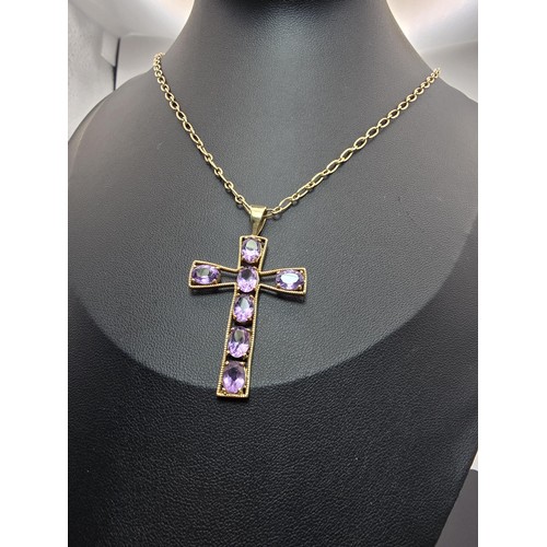 257 - A very pretty hallmarked 9ct yellow gold Cross pendant inset with 7 large faceted amethyst gemstones... 