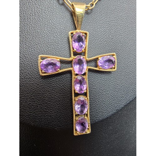 257 - A very pretty hallmarked 9ct yellow gold Cross pendant inset with 7 large faceted amethyst gemstones... 