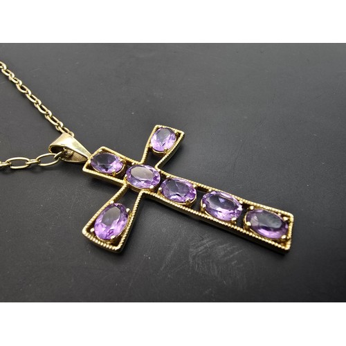 257 - A very pretty hallmarked 9ct yellow gold Cross pendant inset with 7 large faceted amethyst gemstones... 